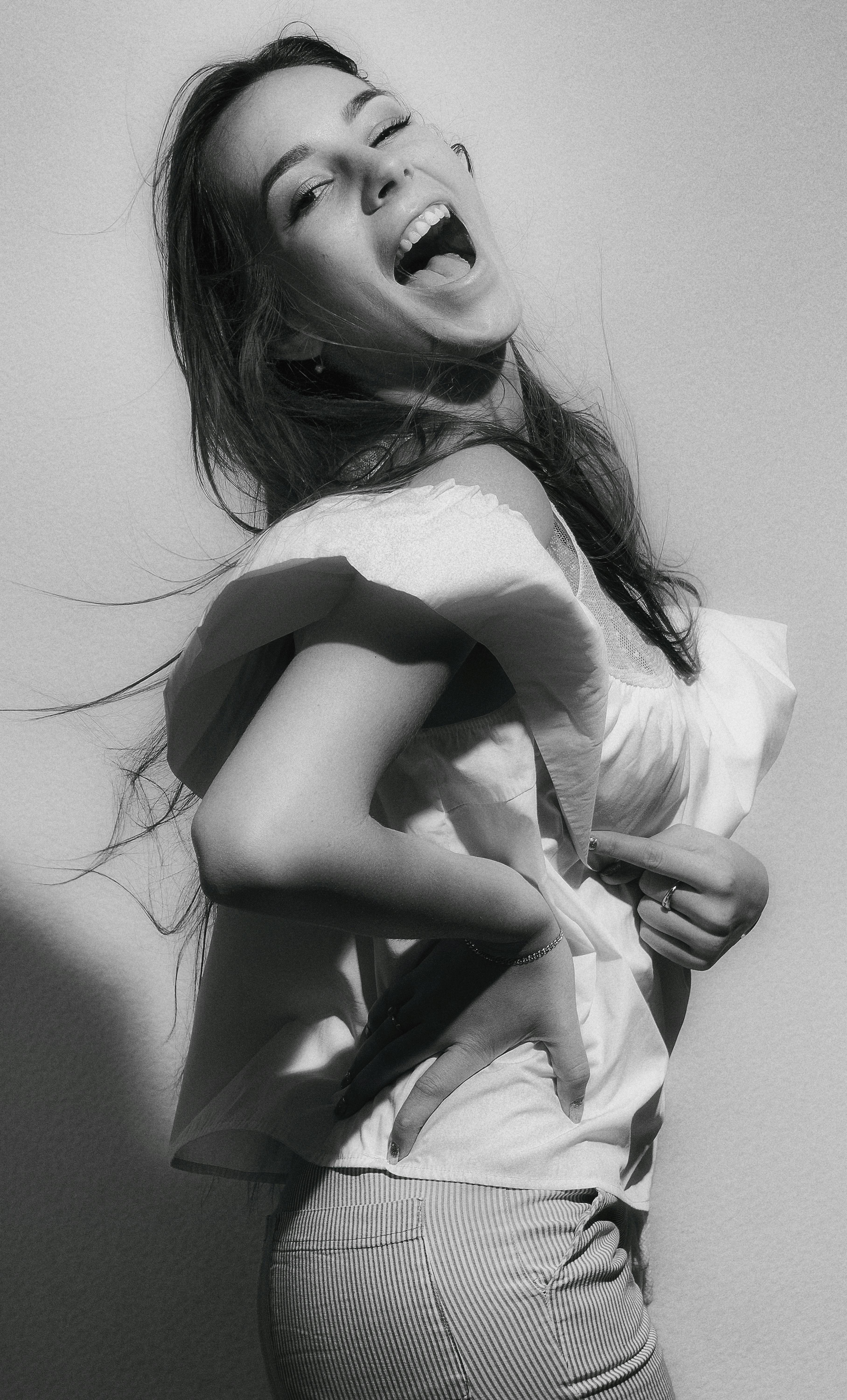 Black and white portrait of a laughing woman in Kyiv. Captures candid joy.