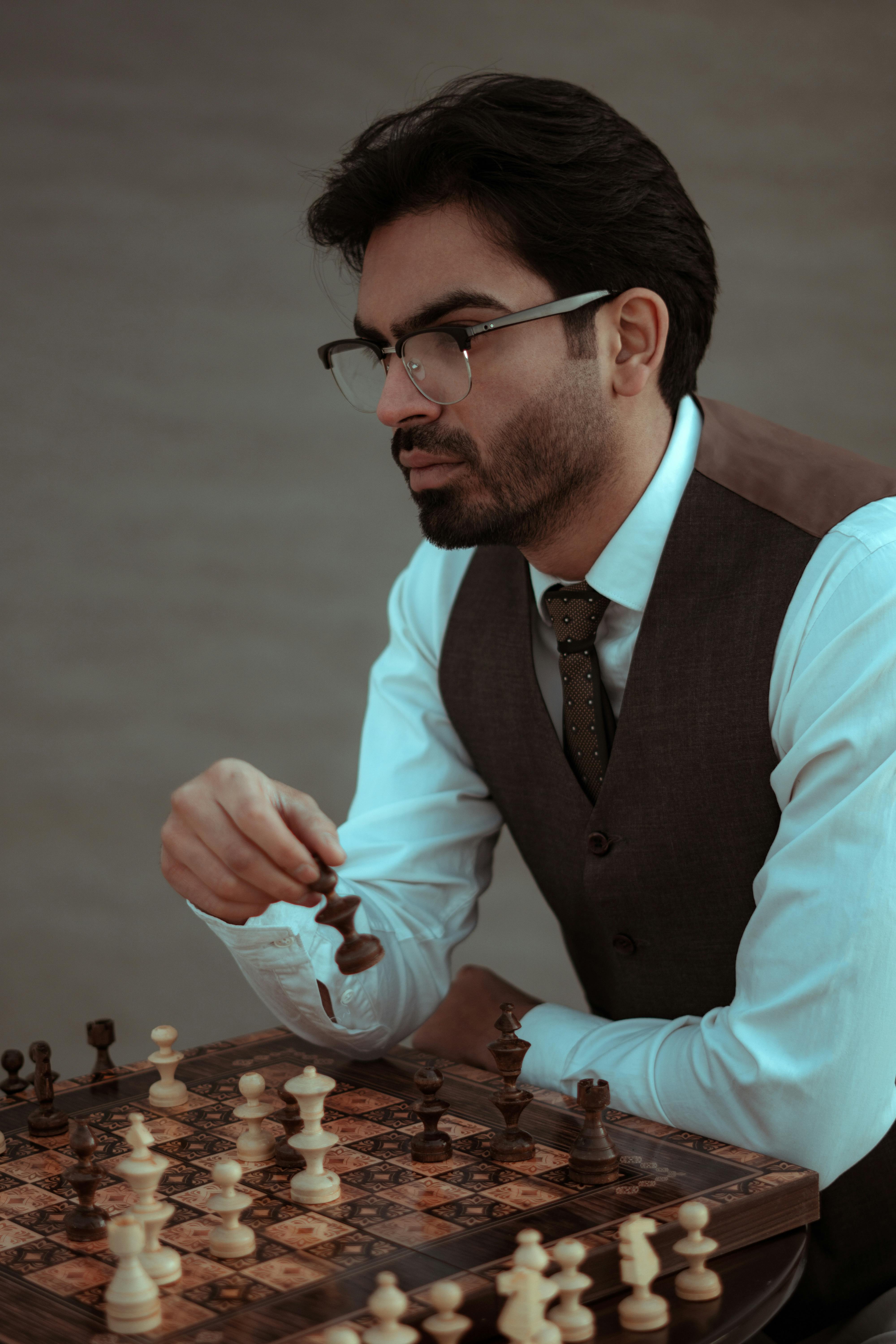 serious man playing chess in studio