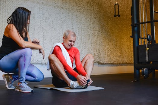 Senior man stretching on yoga mat with coach in gym for a healthy lifestyle.