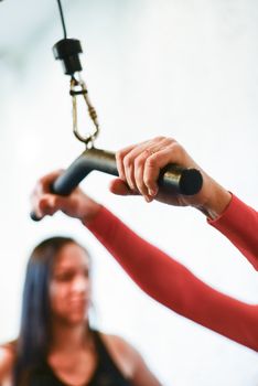Focused shot of hands gripping gym equipment, capturing workout intensity.