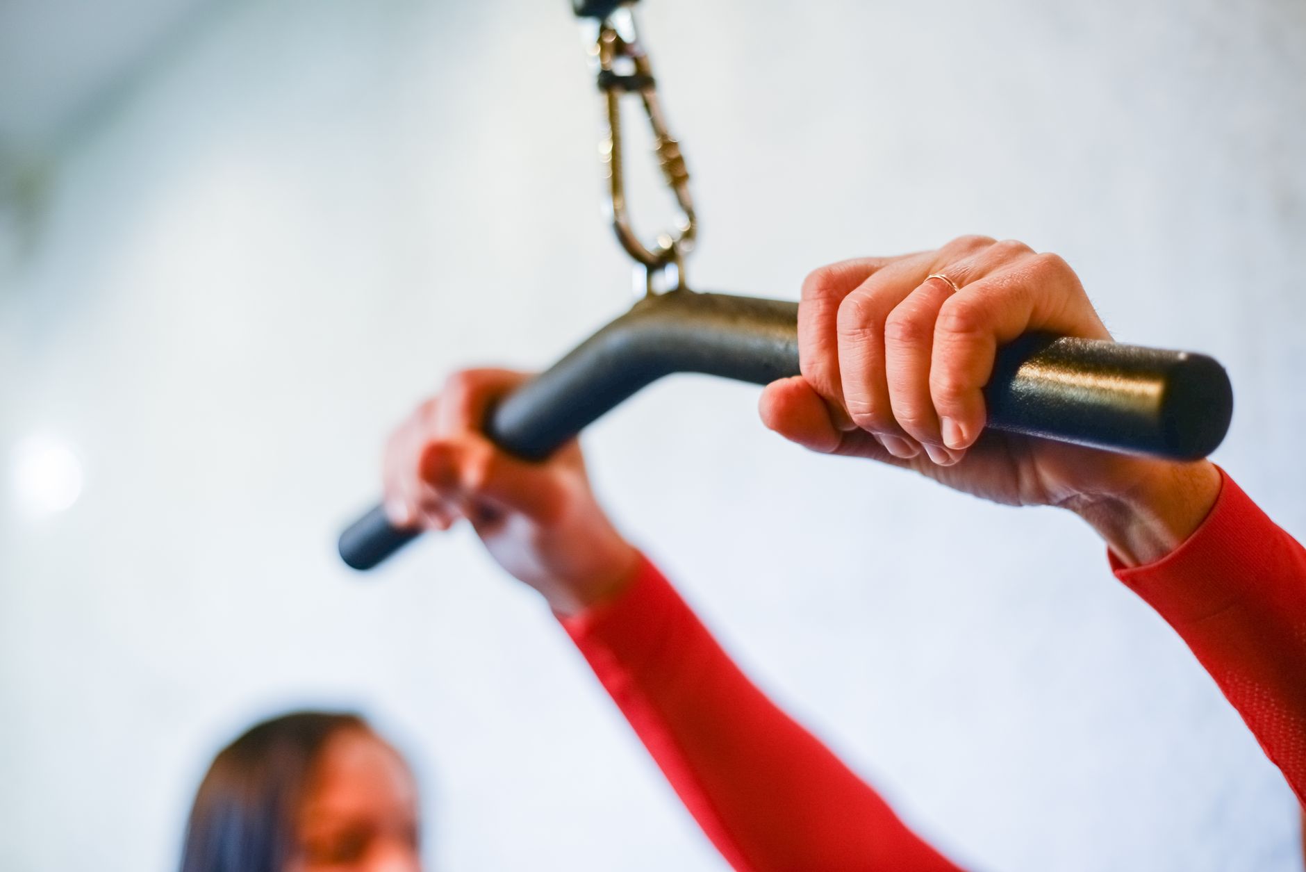 Close-up view of hands grasping a gym bar with focus on strength training and fitness.