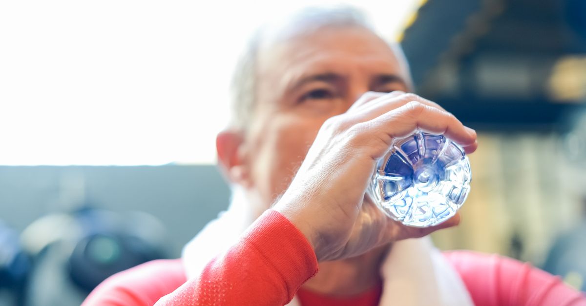 Elderly man in red shirt sipping water during gym session. - Evidence evidence guide for glycerol hydration exercise randomized trial