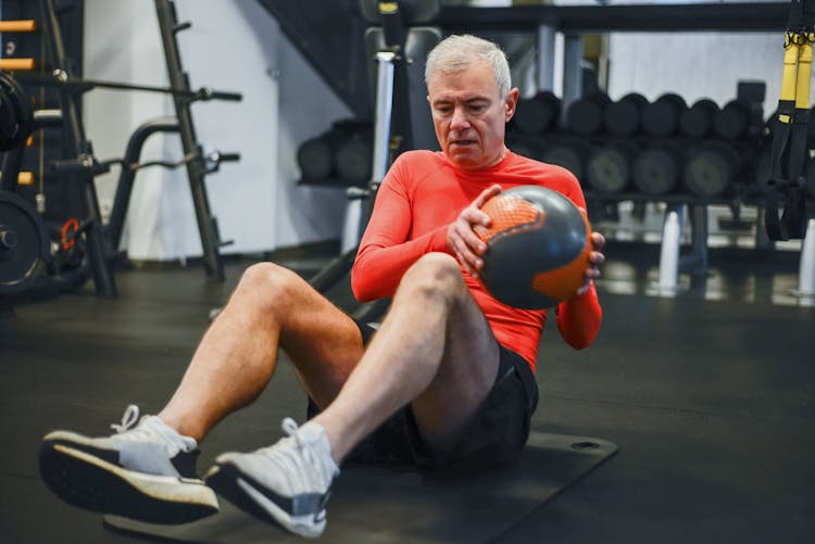 Elderly Man Working Out At The Gym