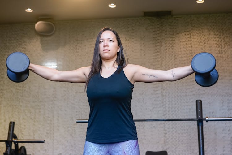 A Woman Lifting Dumbbells 