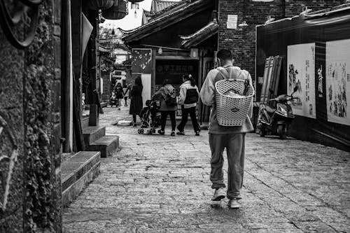 People Walking on a Cobblestone Street