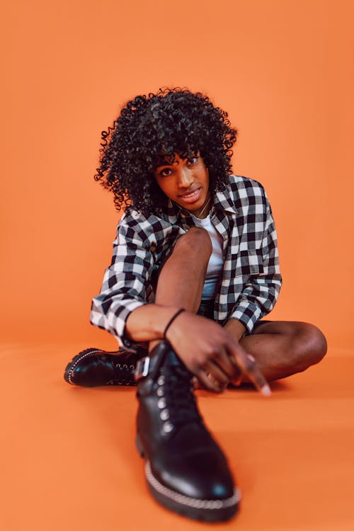 A Woman in a Plaid Shirt Sitting on the Floor