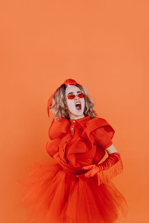 A Woman Wearing Orange Dress and Sunglasses