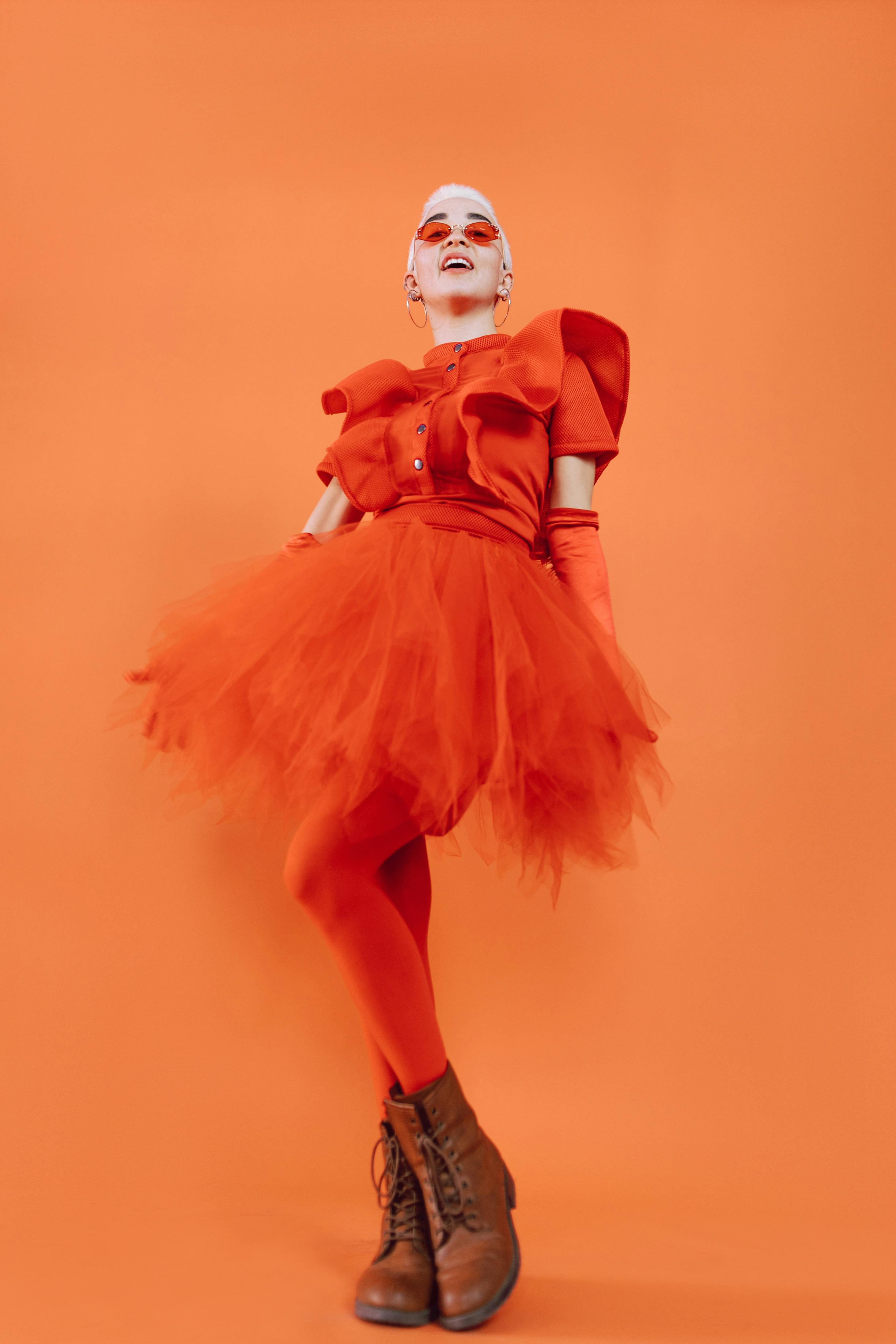 woman in orange dress with white mask