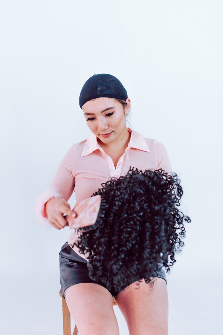 Woman Combing Her Wig