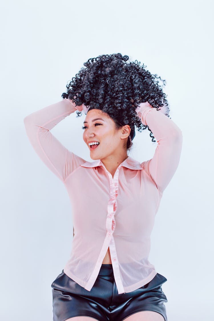 A Woman Putting On Wig 