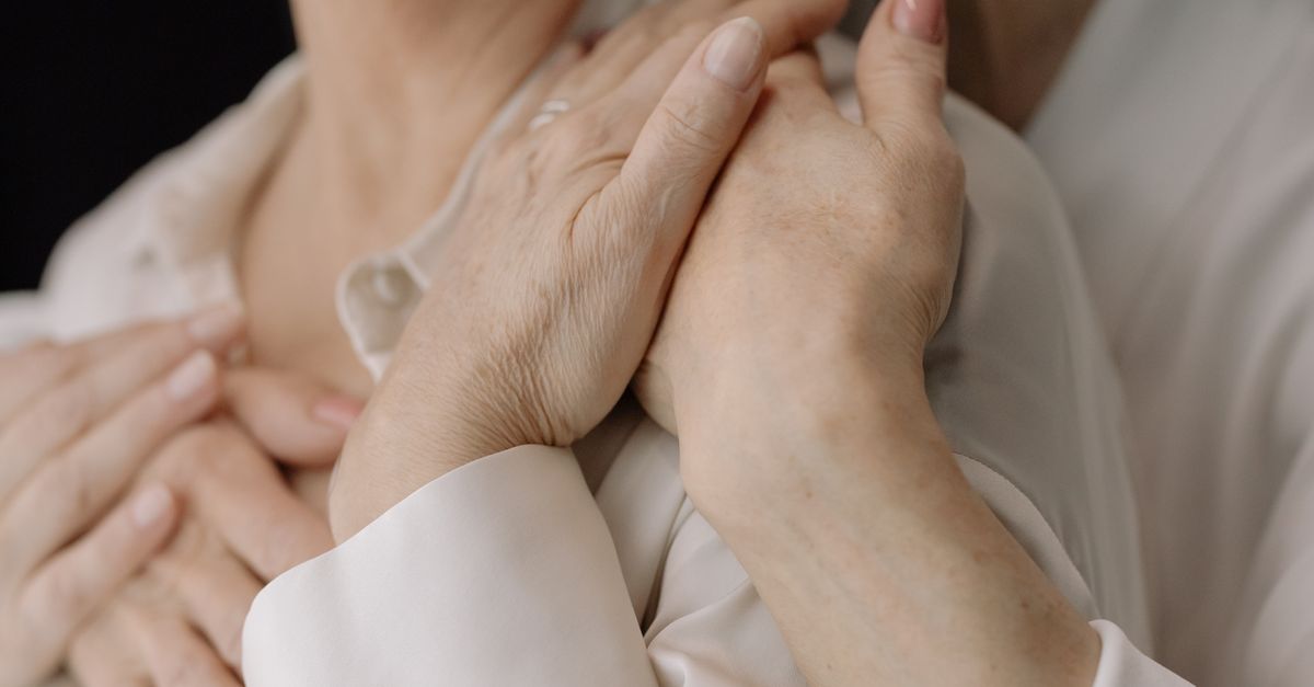 Close-up of elderly women's hands expressing love and connection, symbolizing intimacy and warmth.