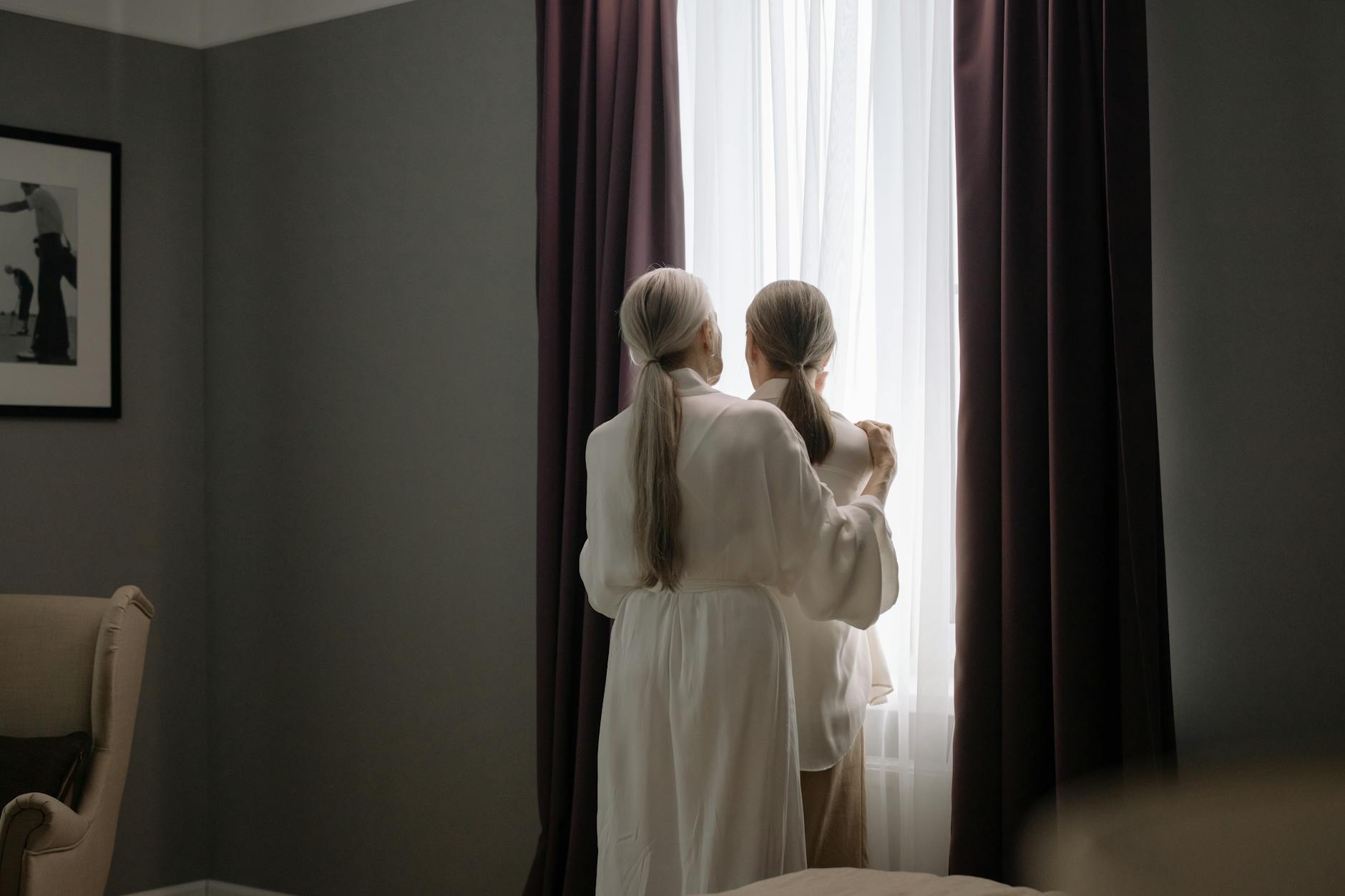 2 Women in White Dress Standing Beside Window