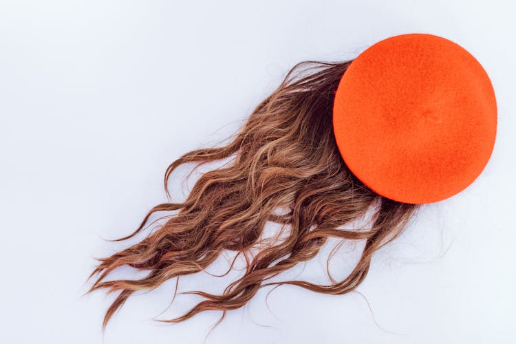 Close-Up Photo Of Hair Wig And An Orange Circle Shape