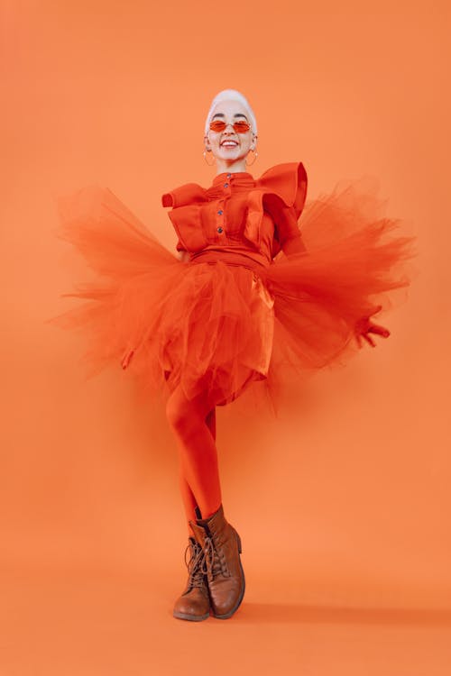 Smiling Woman Posing in Her Fashionable Orange Dress