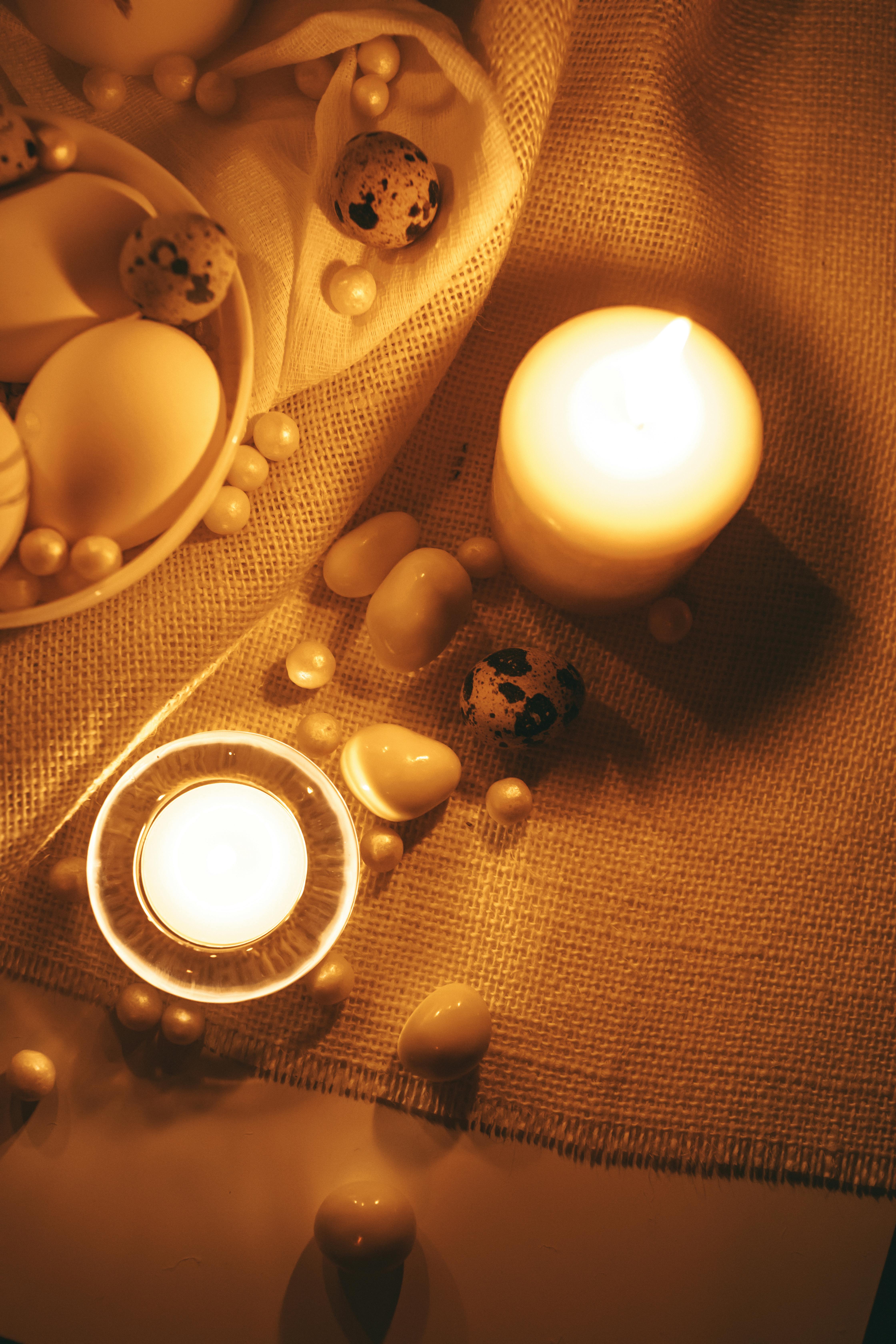 white lighted candles with gold background