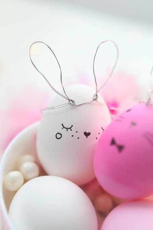 Pink and White Decorated Eggs In A Bowl