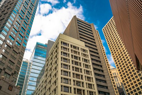 Free Low angle view of diverse skyscrapers in Hong Kong under a bright sky. Stock Photo