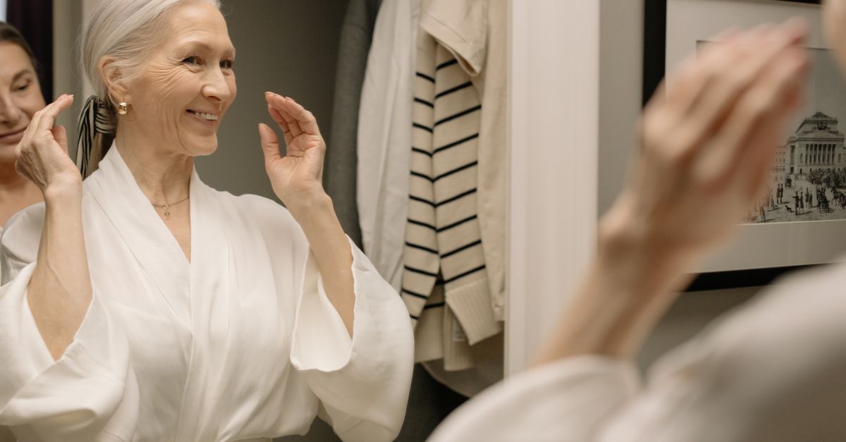 Senior woman standing safely and smiling in her bathroom after safety upgrades
