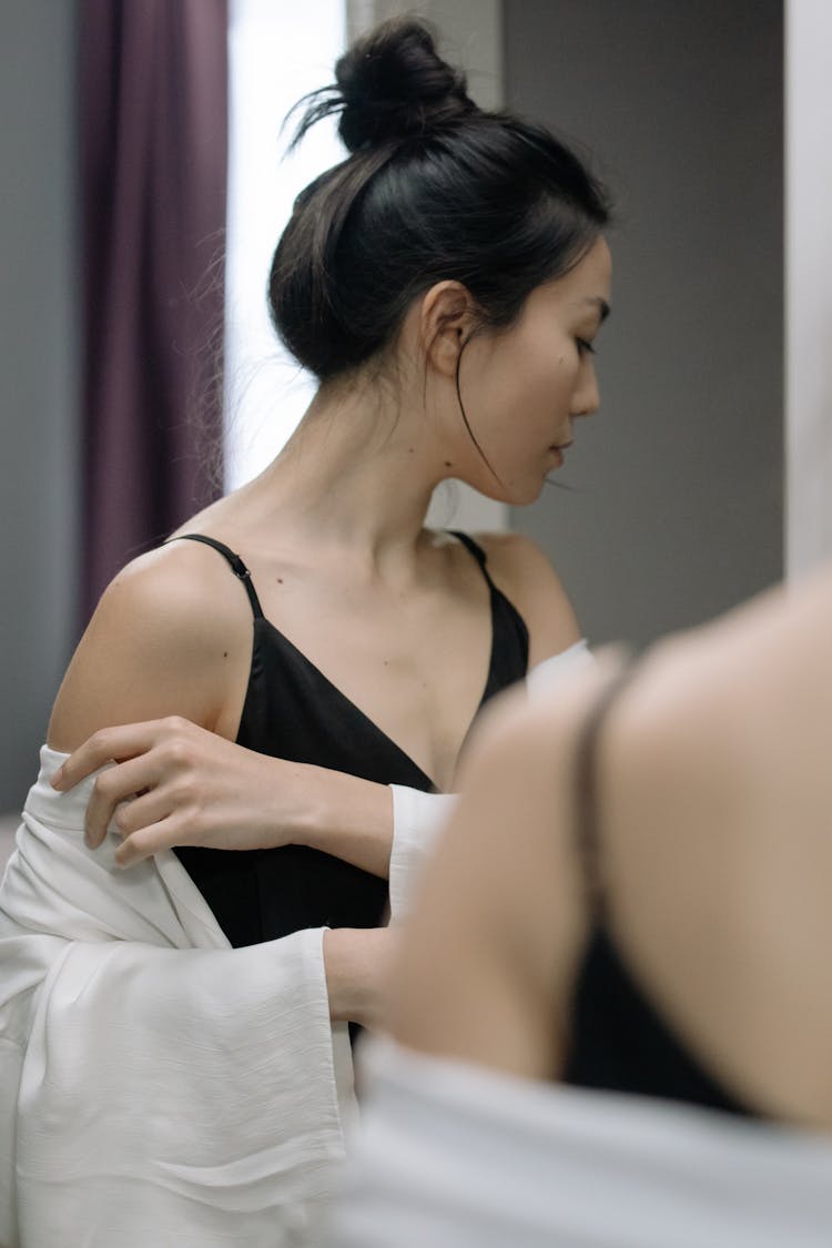 Woman Facing Sideways In Front Of A Mirror