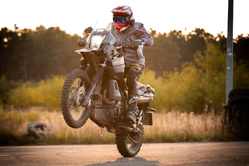Free Man in Black and White Motorcycle Suit Riding Motorcycle Stock Photo