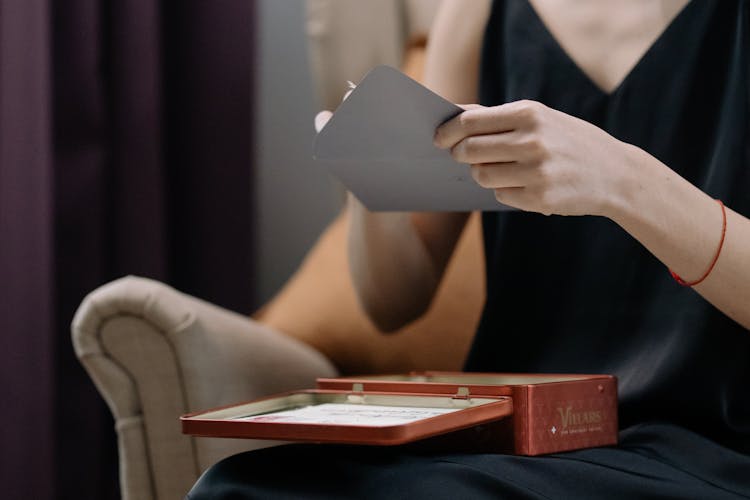 Woman Opening Gray Envelope