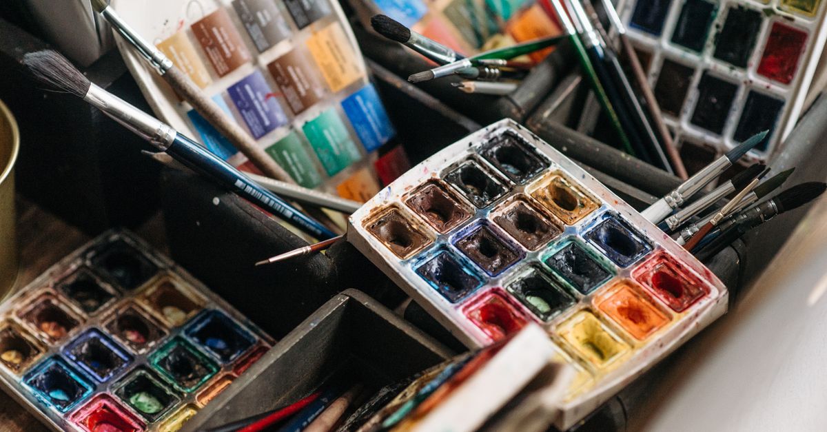 A colorful array of watercolor paints and brushes perfect for creative art projects.