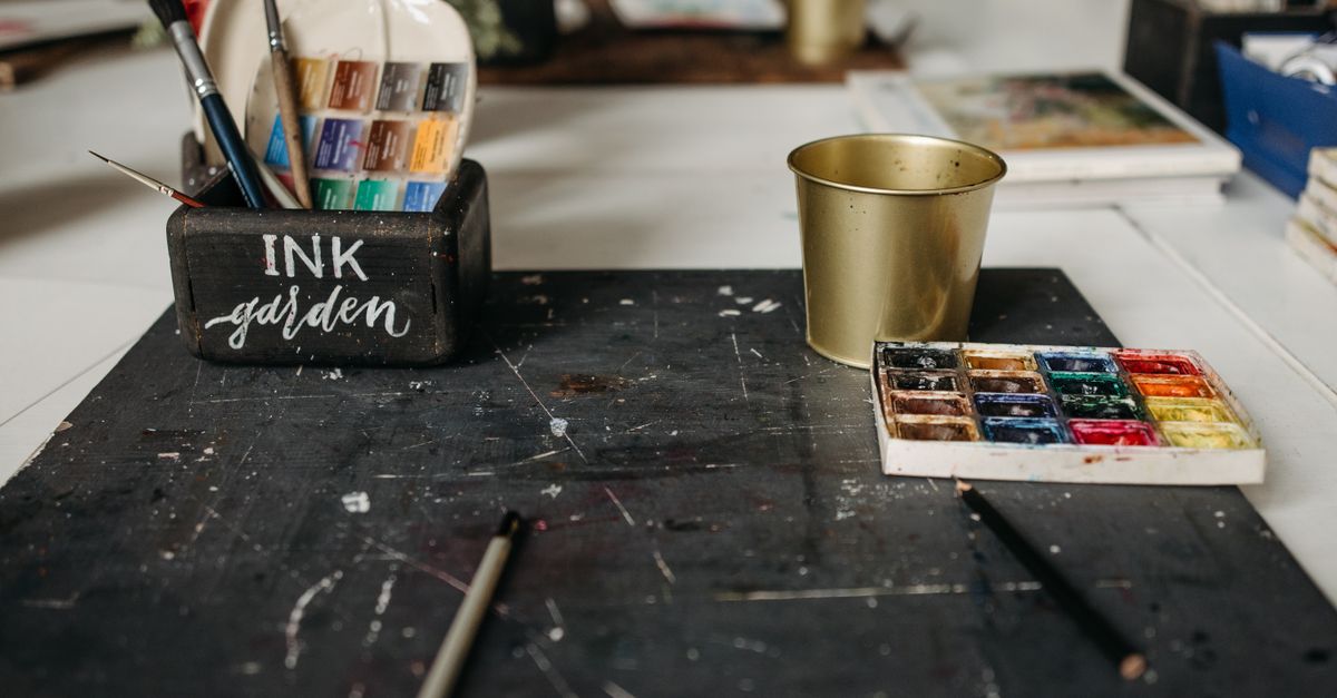 A creative studio desk with brushes and materials for producing visual content
