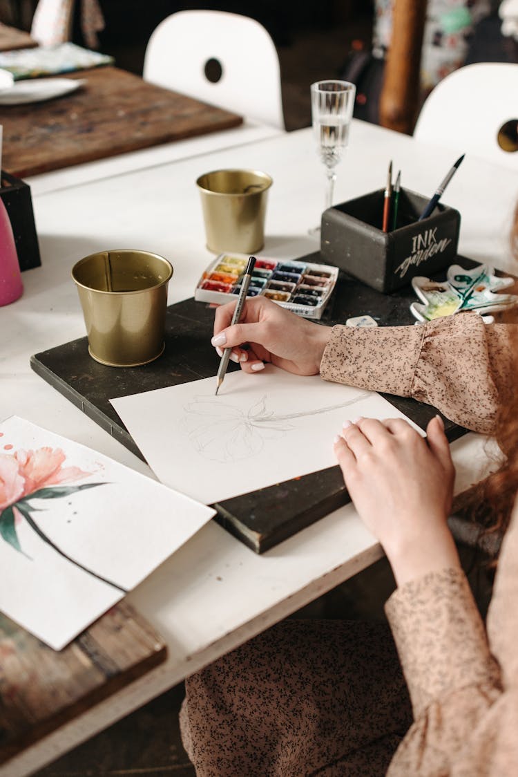 A Person Drawing On White Paper