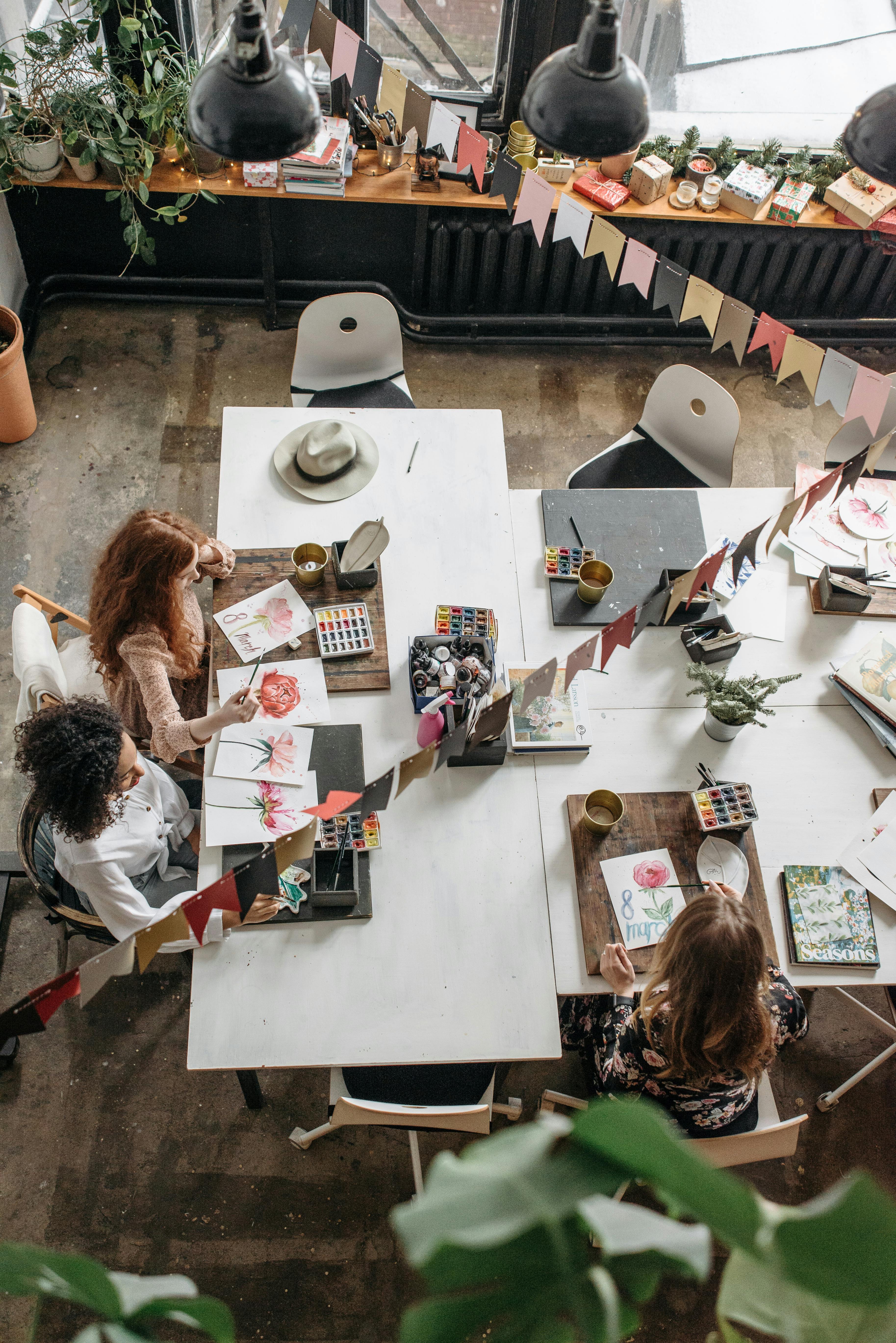 people sitting at table with assorted items