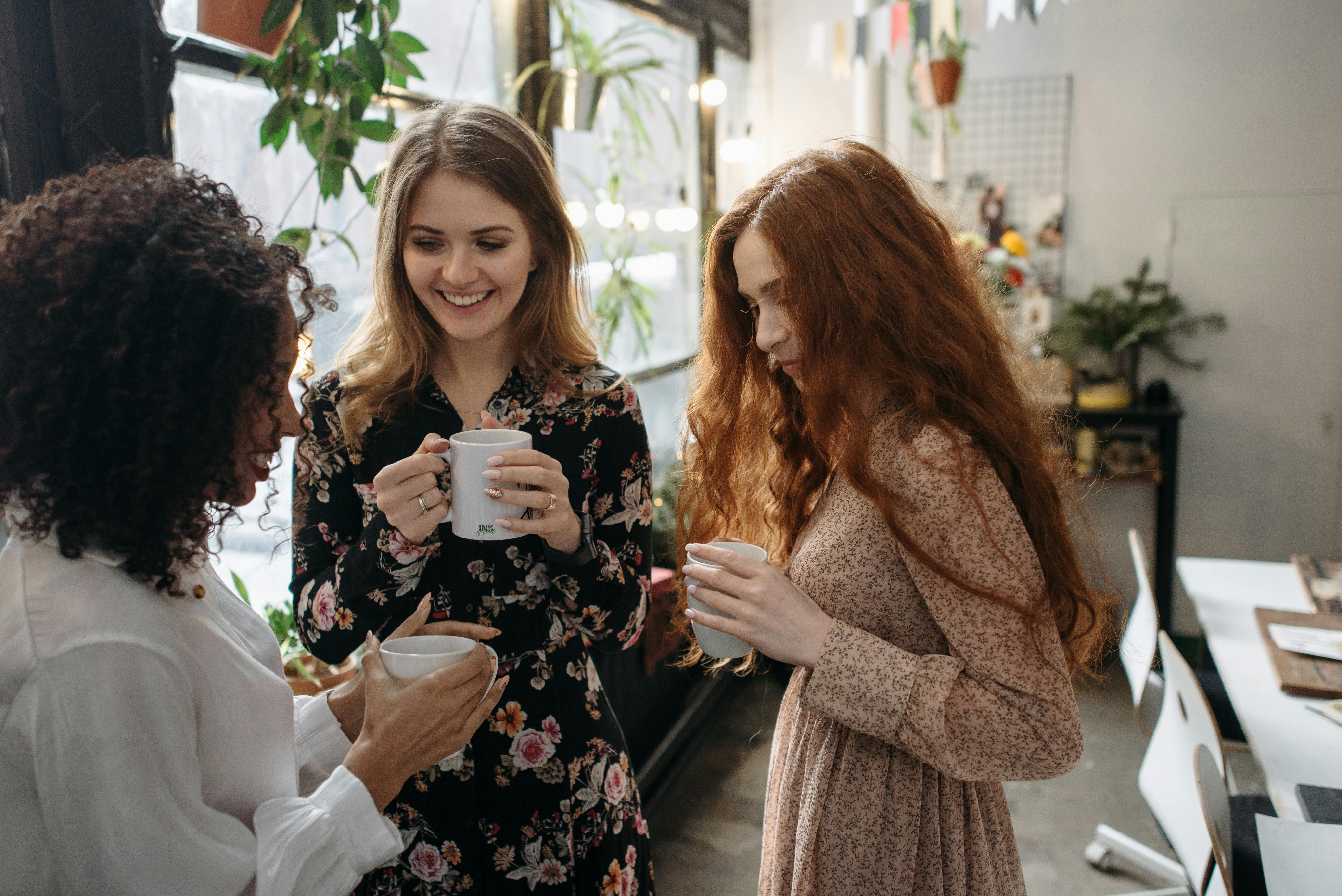 2 women smiling while standing