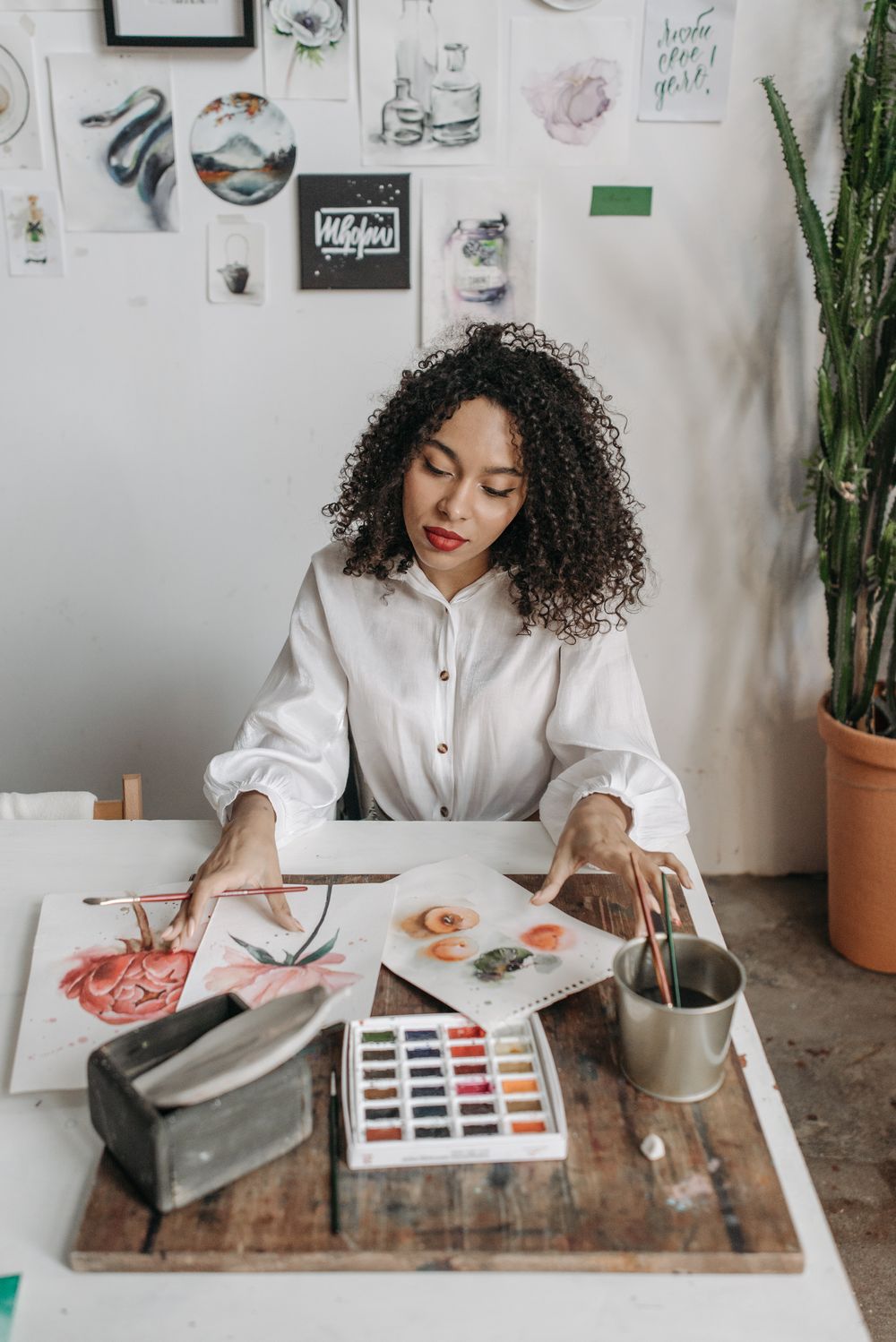 Painting watercolours at a desk