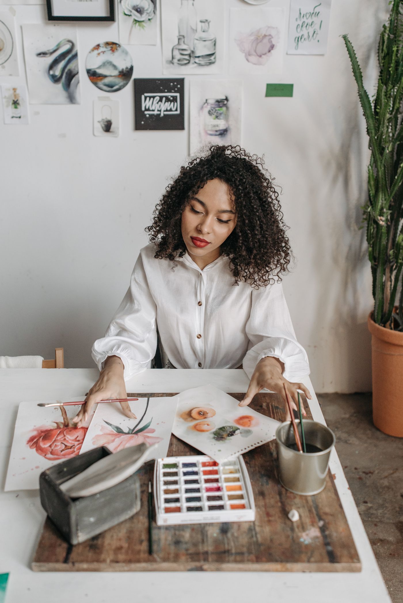 Painting delicate watercolours at the studio table