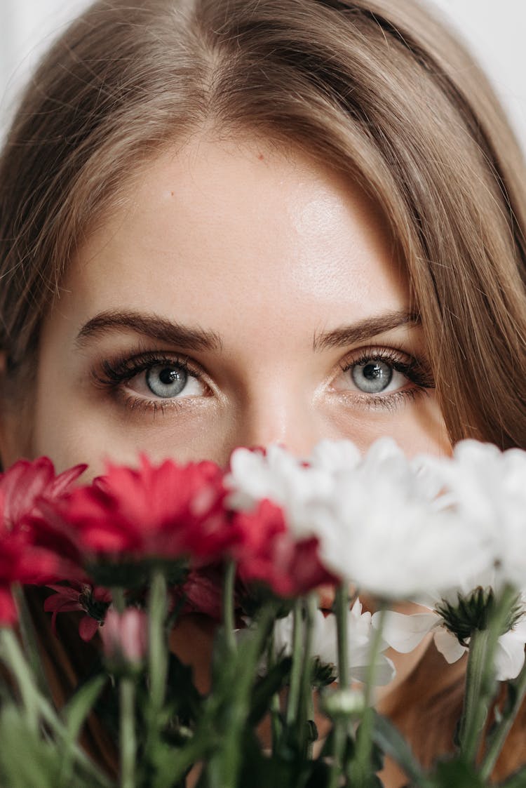 Flowers In Front Of Woman's Face