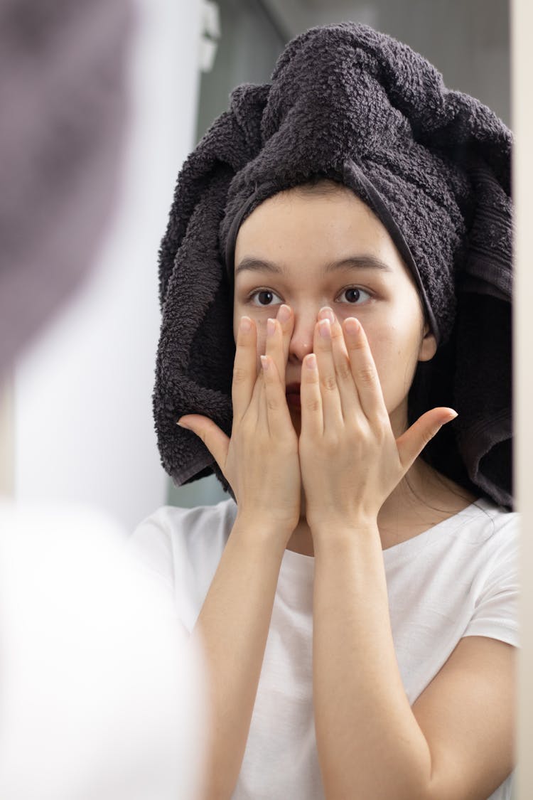 Woman In White Crew Neck T-shirt Patting Her Face