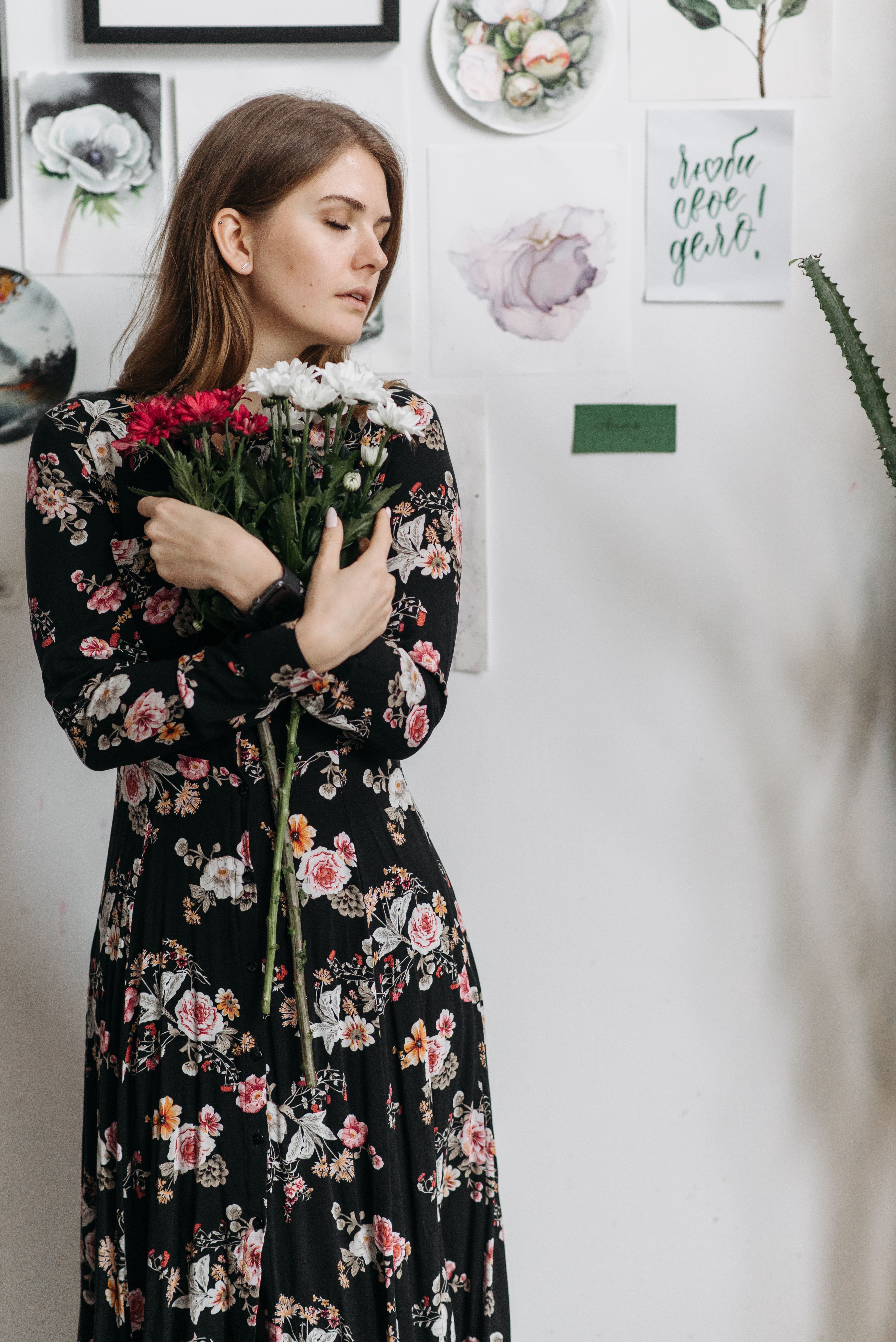 Woman in Black Dress Holding Flowers · Free Stock Photo