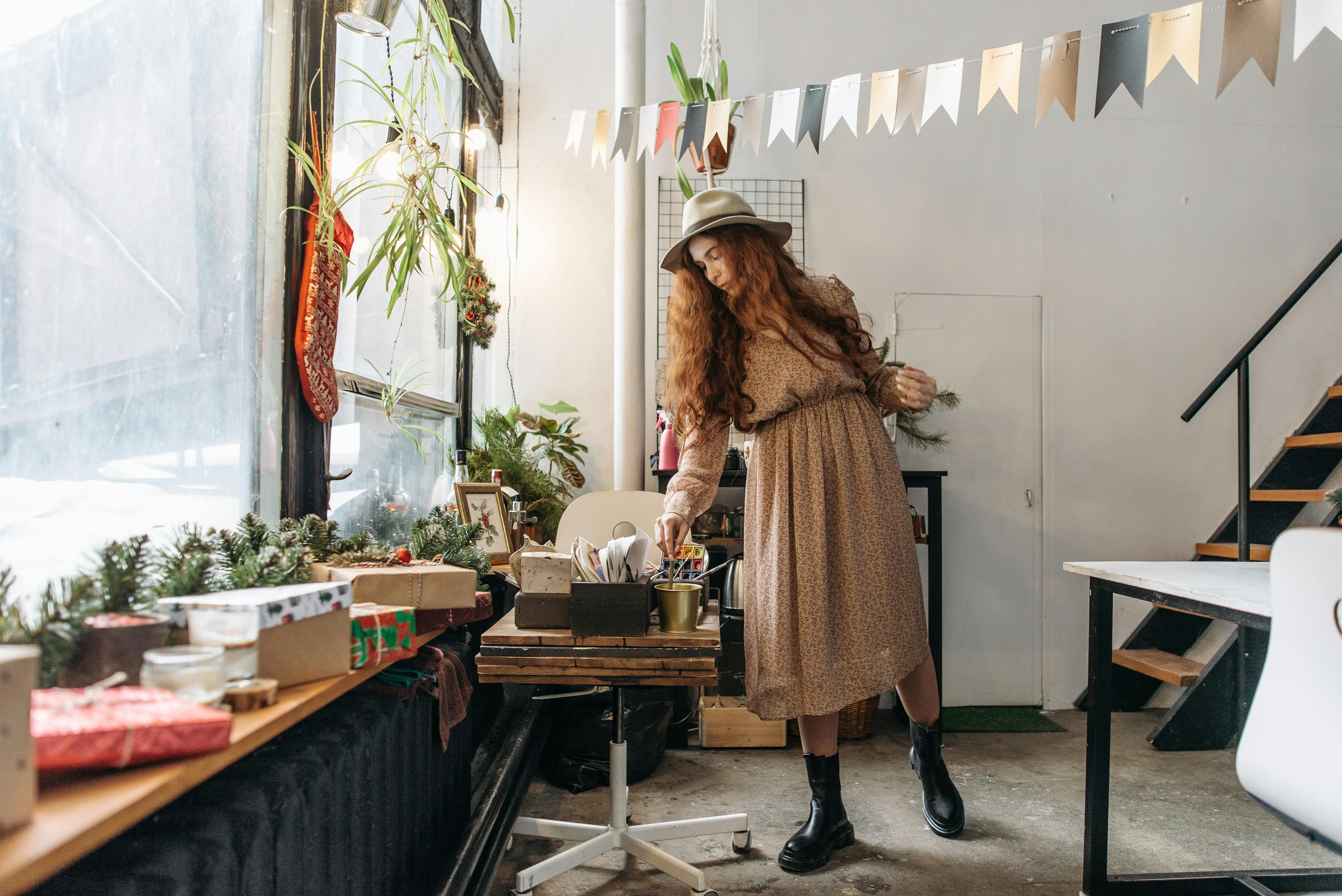 woman in brown coat standing beside brown wooden table