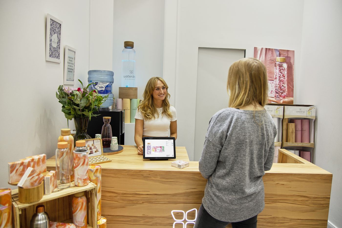 A beauty salon receptionist welcoming a client
