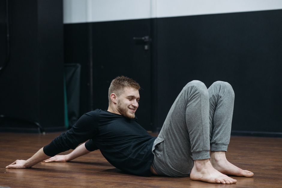 A person performing cool-down stretches on the floor after a workout, emphasizing flexibility and recovery - improve fitness results A person performing cool-down stretches on the floor after a workout, emphasizing flexibility and recovery - improve fitness results