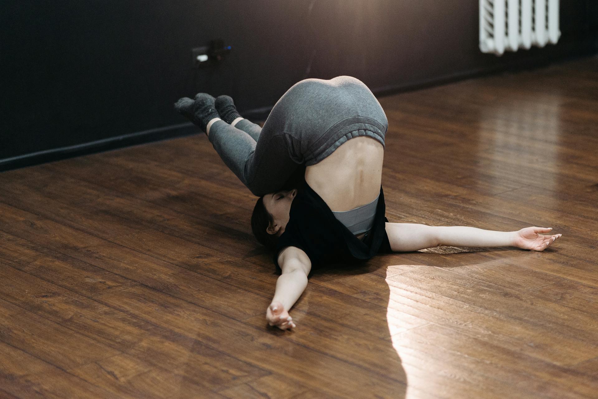 A Woman in Upside Down Position on the Floor