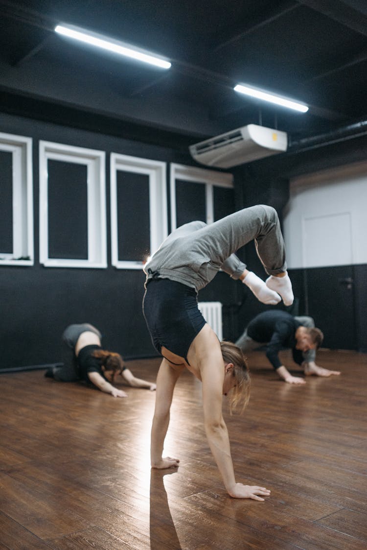 Woman Doing A Hand Stand At A Studio