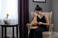 Woman in Brown Tank Top Sitting on White Sofa Chair