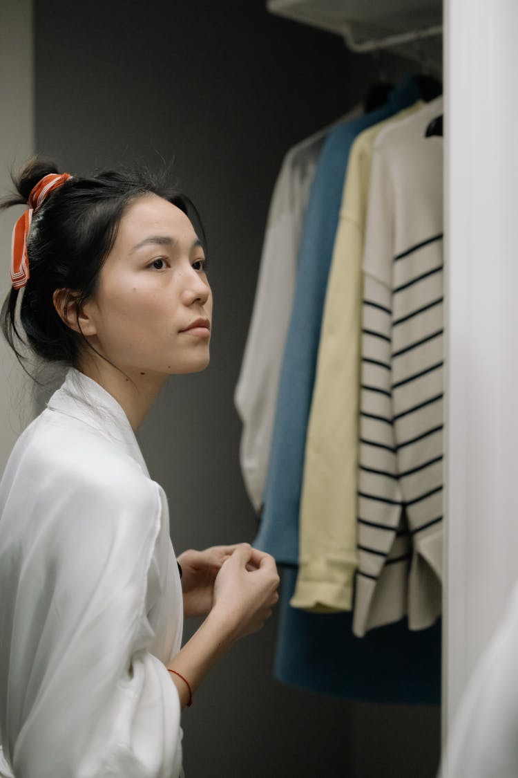 Beautiful Woman And Clothes In The Closet