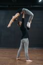 Woman in Black Tank Top and Gray Pants Doing Yoga