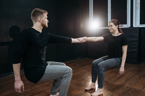 A Man and a Woman Holding on Each Other's Wrists