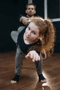 Couple engaging in stretching exercises indoors, emphasizing balance and coordination.