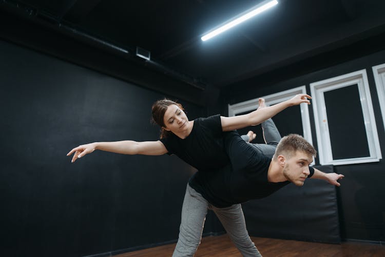 A Man And A Woman Dancing In A Dance Studio