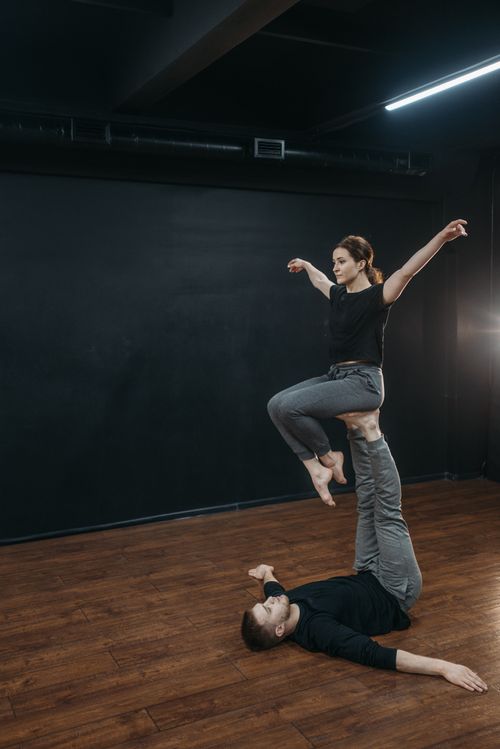 Free Two dancers in a dance studio demonstrate balance and flexibility with a unique pose. Stock Photo