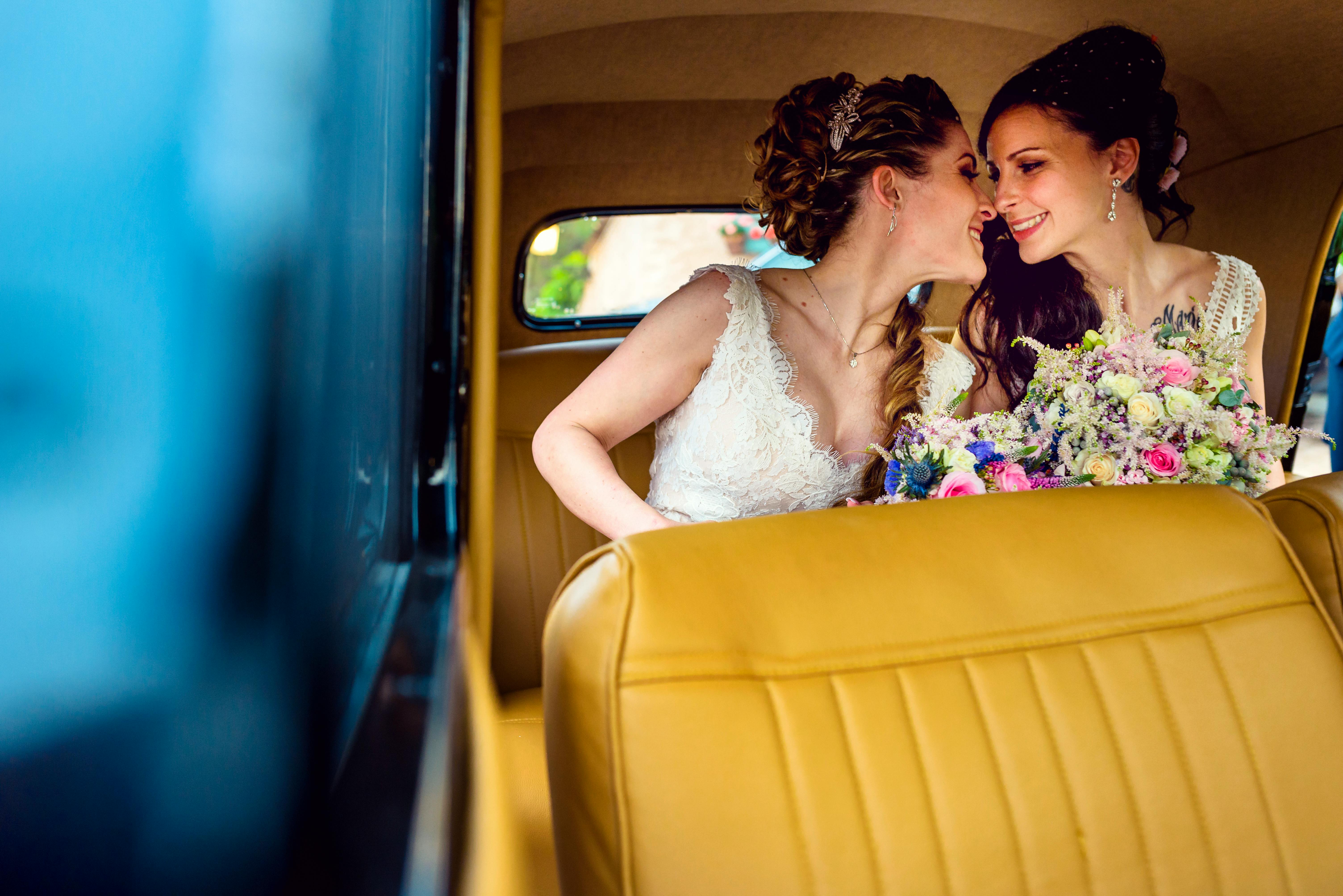 woman in white wedding dress sitting on yellow car seat