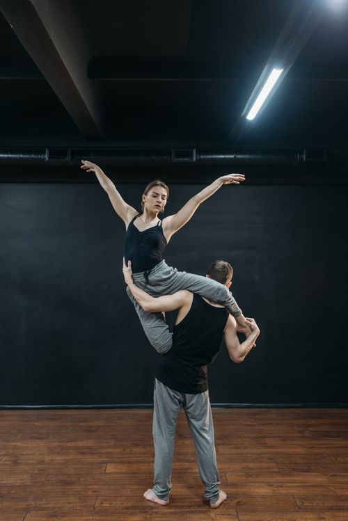 Free Elegant dance performance showcasing strength and balance in a studio. Stock Photo