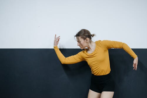 Woman Wearing a Long Sleeves Shirt Dancing
